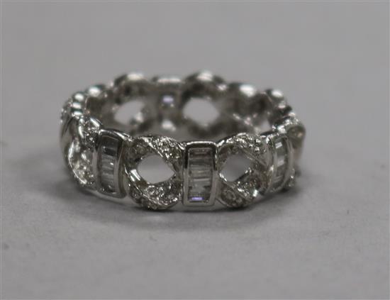 A modern 18ct white gold and diamond set pierced eternity ring, size M.